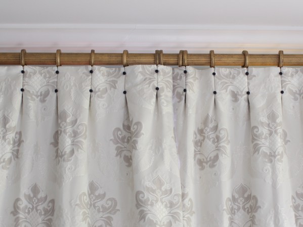 cream drapes with navy covered buttons