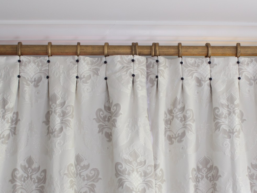 cream drapes with navy covered buttons